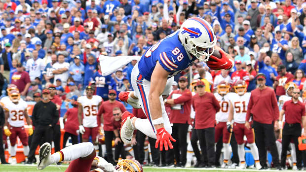 Buffalo Bills tight end Dawson Knox (88) is upended by Washington Football Team cornerback Bobby McCain (20) after making a catch in the fourth quarter at Highmark Stadium.